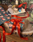 THE BUNS (c) adorable cute Christmas rabbits gift wrap wrapping paper in traditional holiday colours with buns in Santa hats and stockings