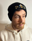 aborable THE BUNS (c) kawaii art rabbit cute spring bee bumble bun embroidered thermal hat black beanie featuring daisies